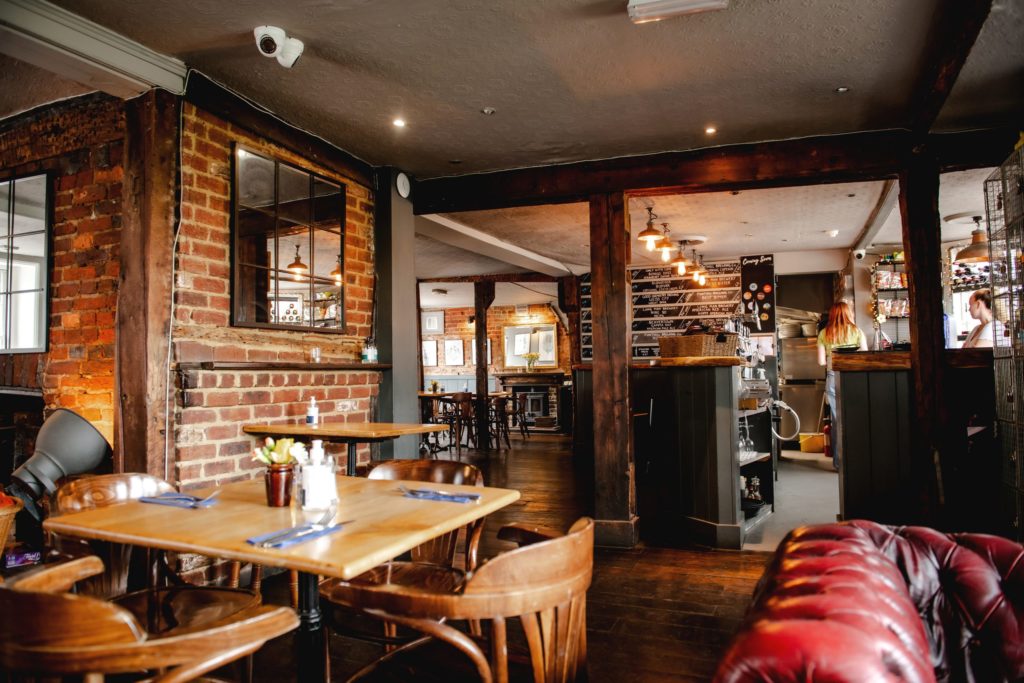 Interior of The George pub - featuring lush dark wood and leather furniture
