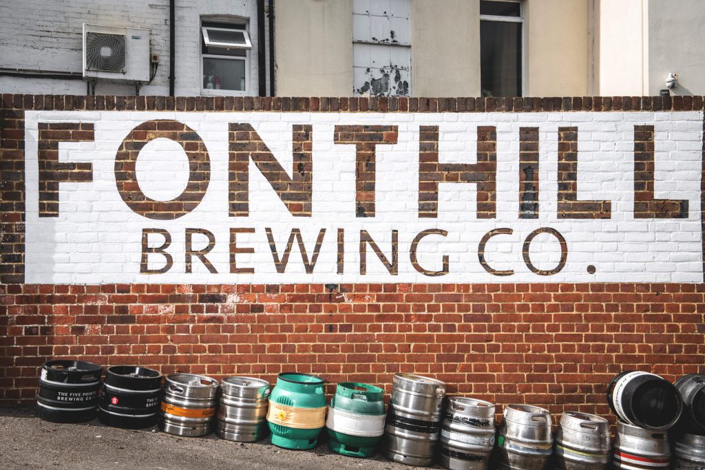 Fonthill Brewing Co.'s logo stencilled on to the brick wall outside