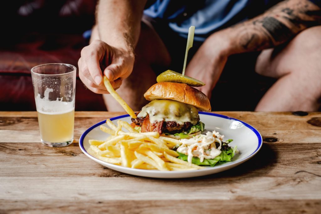 Man eating the George pub's burger