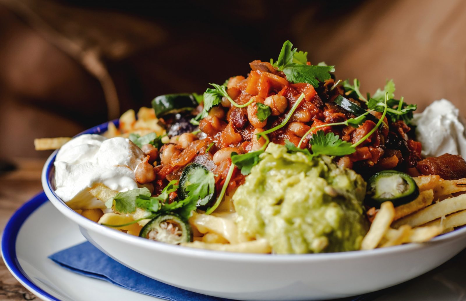Cheesy fries topped with three bean chilli, guacamole, sour cream, jalapenos, and chipotle chilliflakes