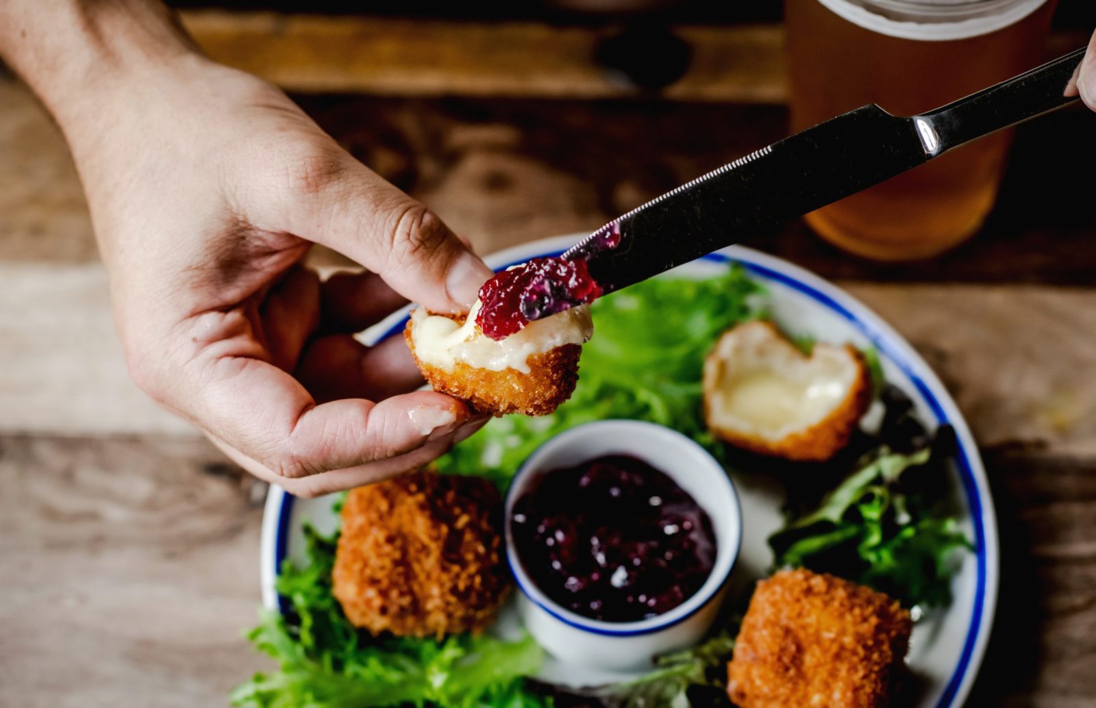 spreading cranberry sauce on to a brie bites at the George pub, Tunbridge Wells