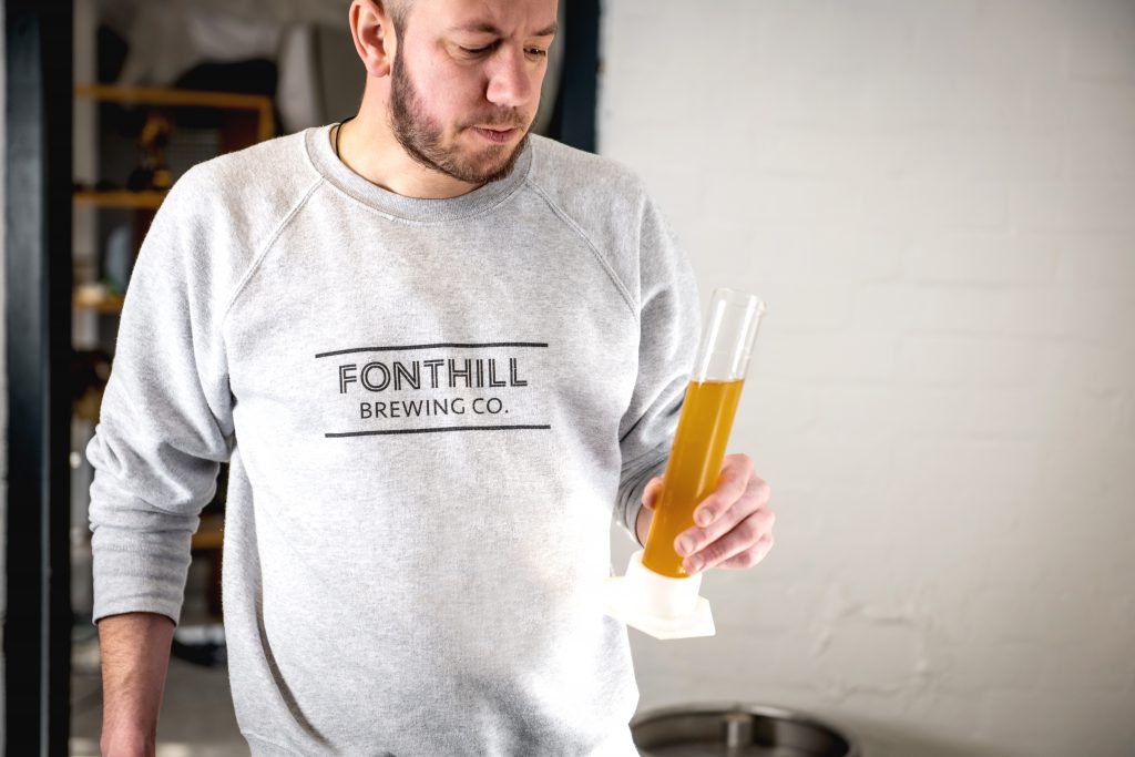 Head brewer, Paul testing his batch of fruity IPA