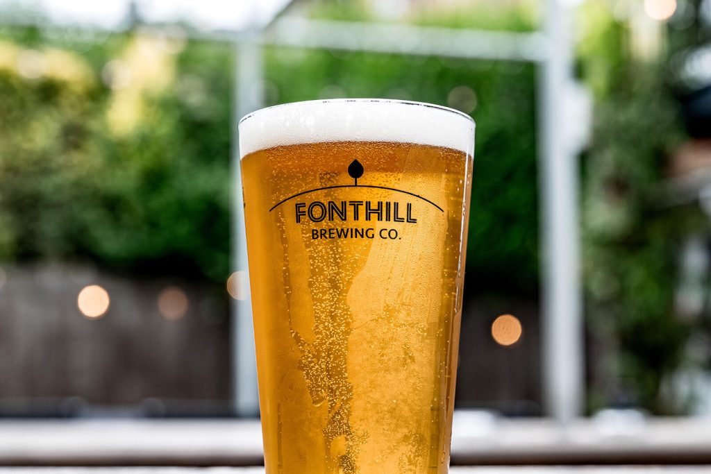 A pint of Fonthill Lager served in  shaker beer glass types at The George pub in Tunbridge Wells