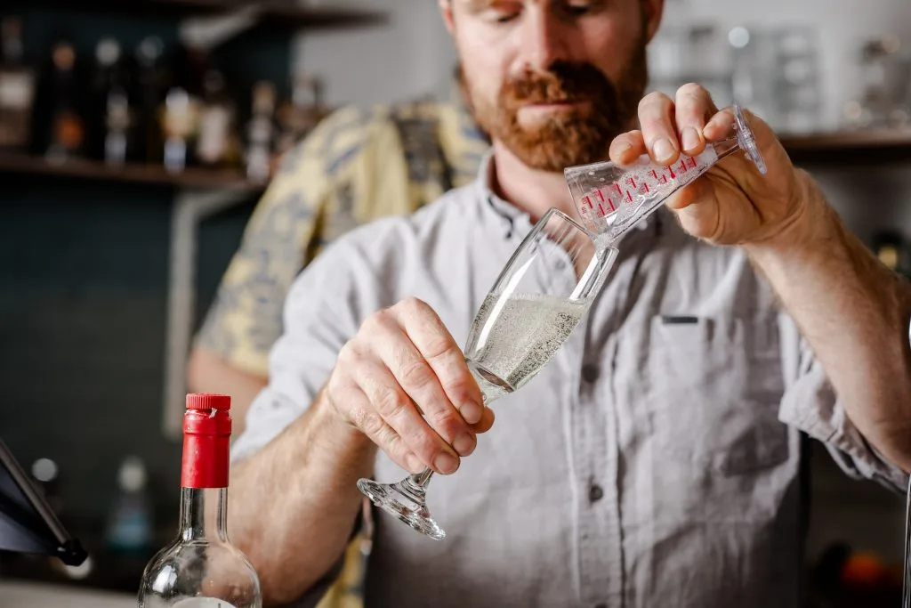 Ali from the taproom's bar constructing a Spritz