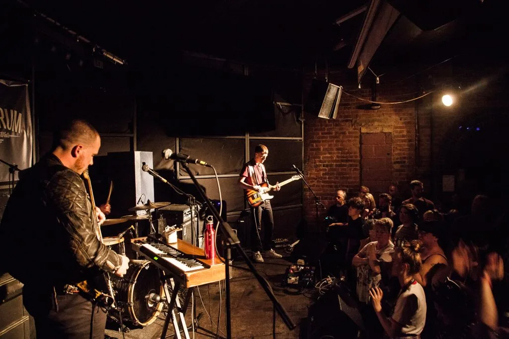 A band plays music for a crowd inside The Forum venue in Tunbridge Wells