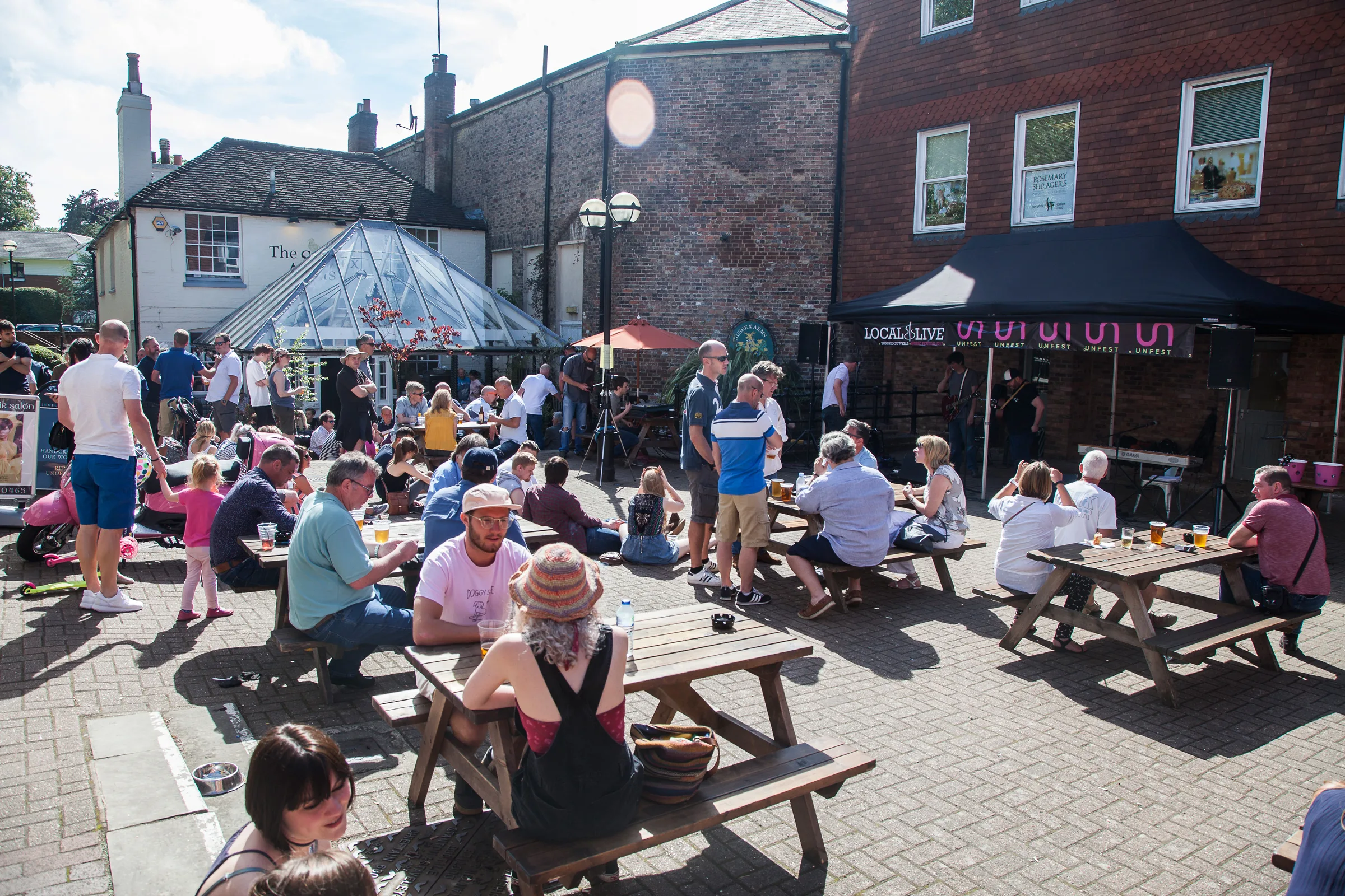 Crowds gather at the Local & Live outdoor stage on Sussex Mews during Unfest